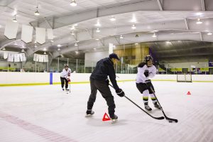 player skating around cone & Rob